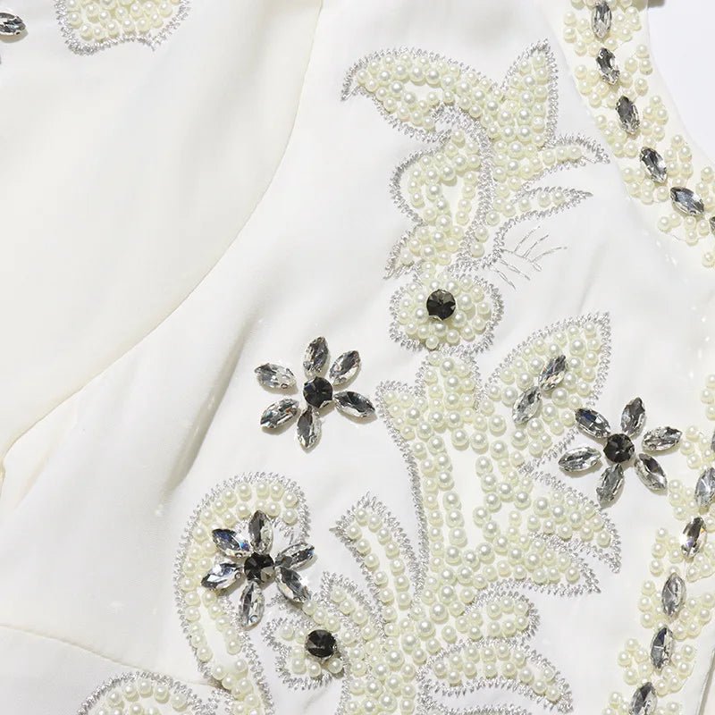 Naurelle featuring a detailed embellished jacket and a pleated maxi dress - Lu Di Lusso